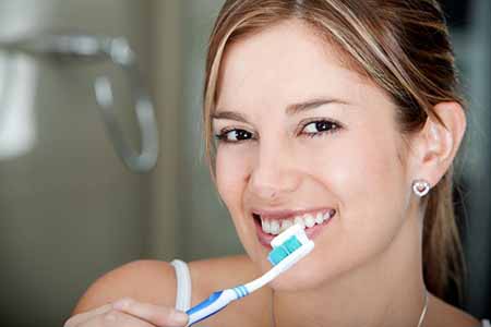 dental cleaning colorado springs - woman brushing her teeth