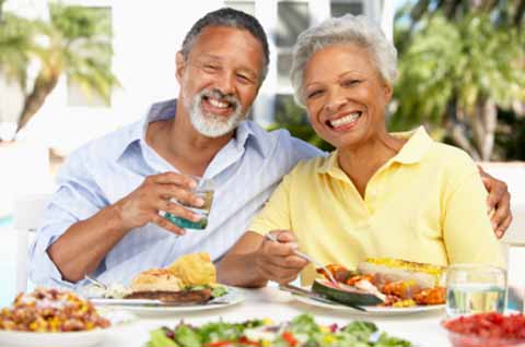 root-canal-colorado-springs-smiling-older-couple-at-table